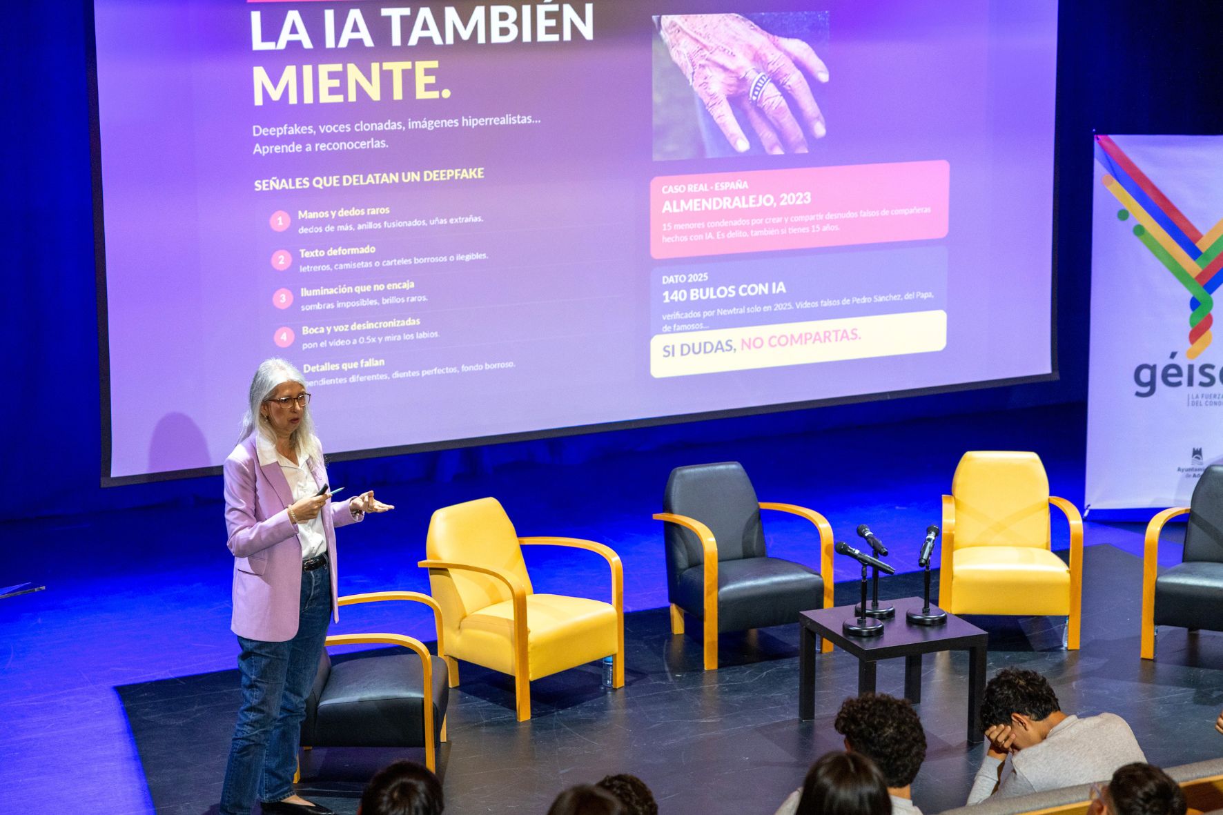 Mónica Radován en escenario durante una conferencia con la diapositiva 'La IA también miente'